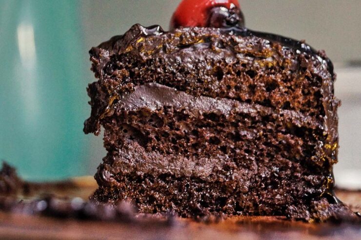 moist chocolate cake with chocolate filling topped with berries