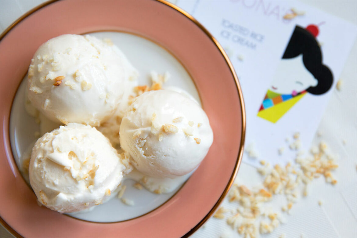 three scoops of ice cream in a white and pink dish