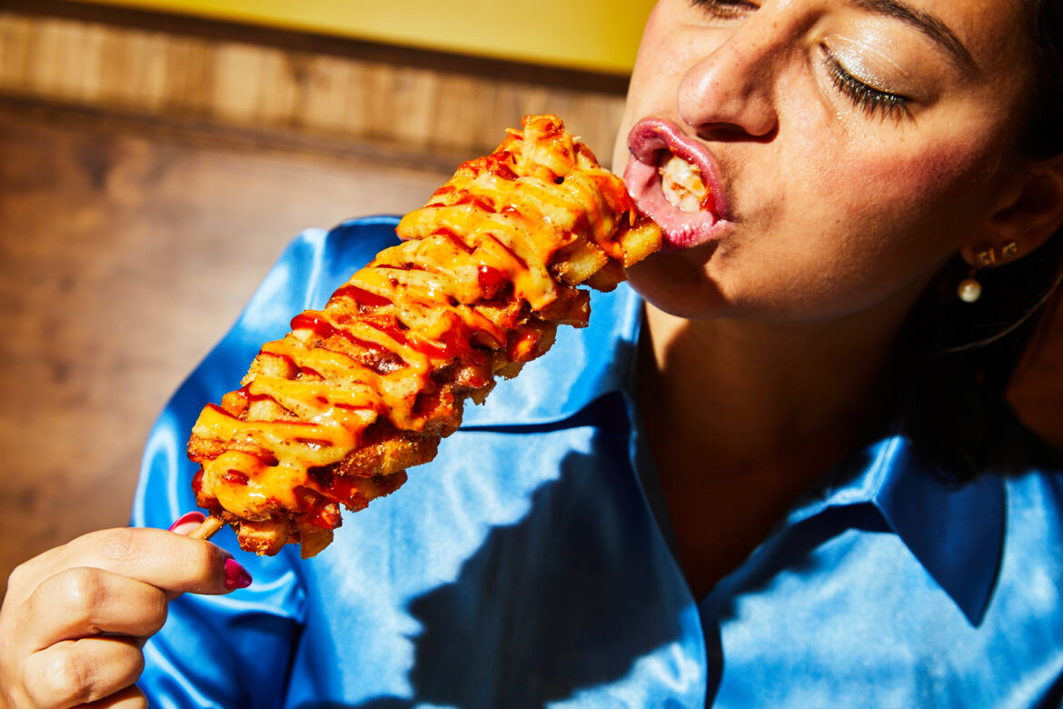 girl eating corndog